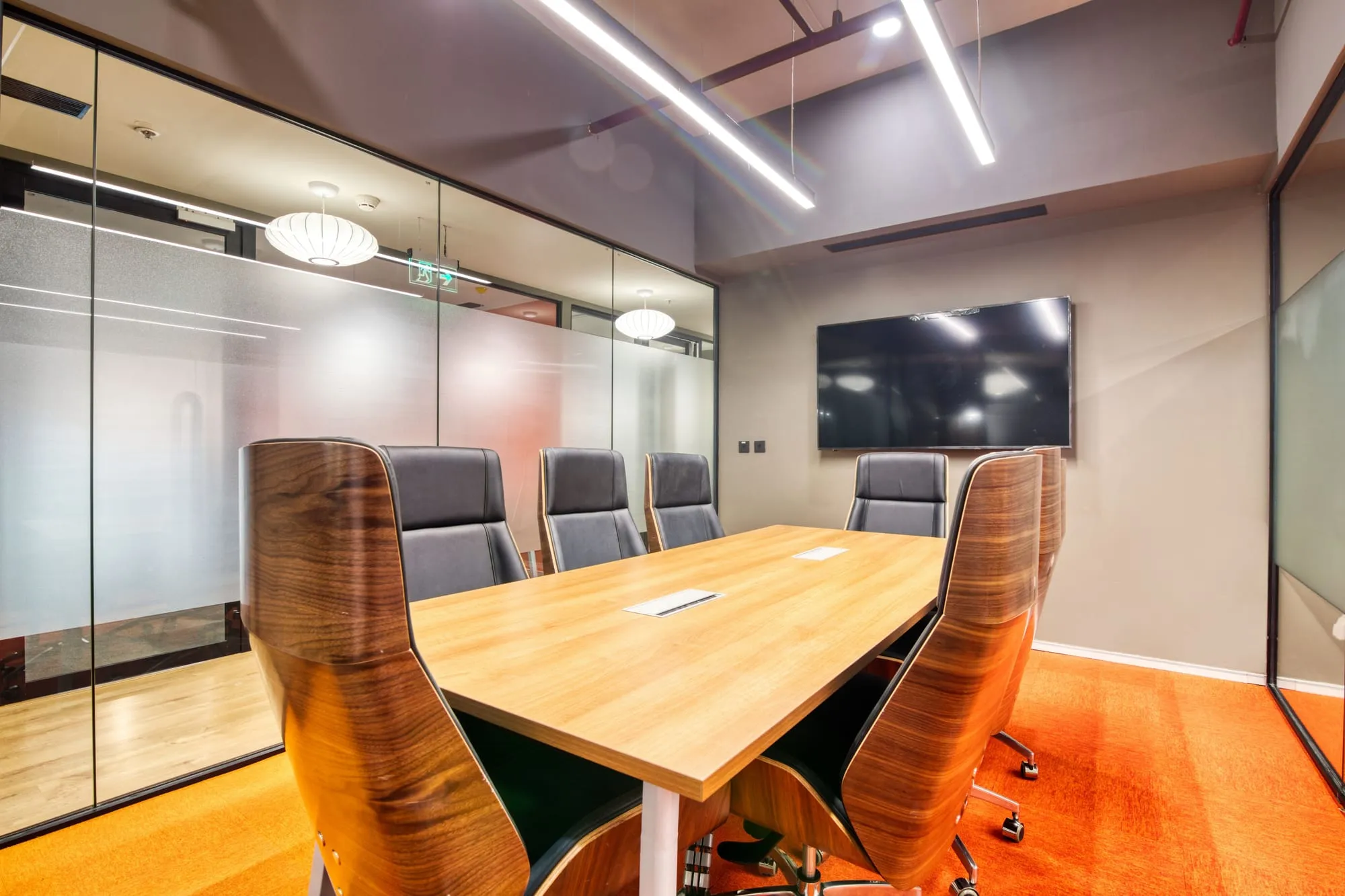 Boardroom with a long wooden table and leather chairs