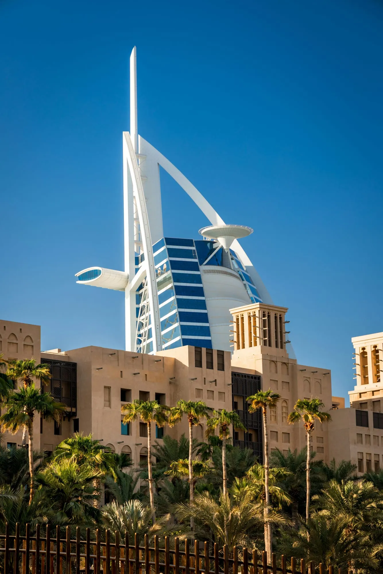 Burj Al Arab rising above traditional wind towers
