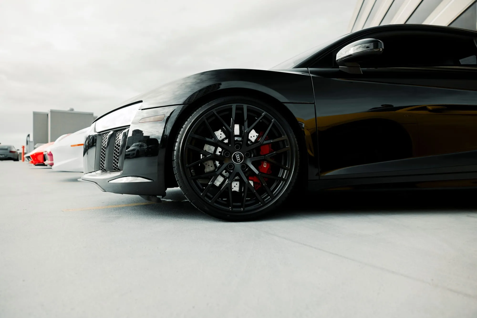 Black sports coupe in a white studio