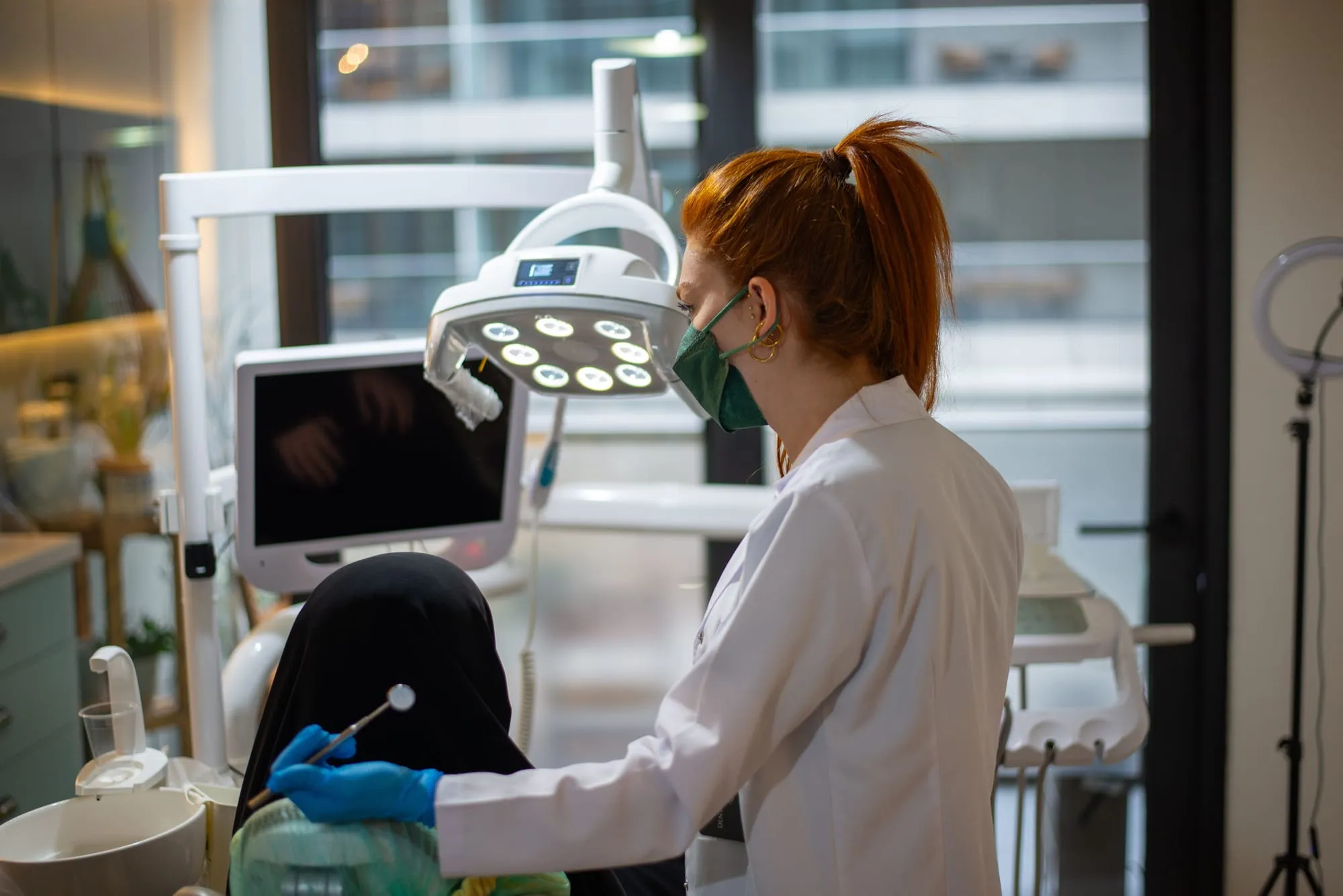 Dentist treating a patient in a modern dental suite
