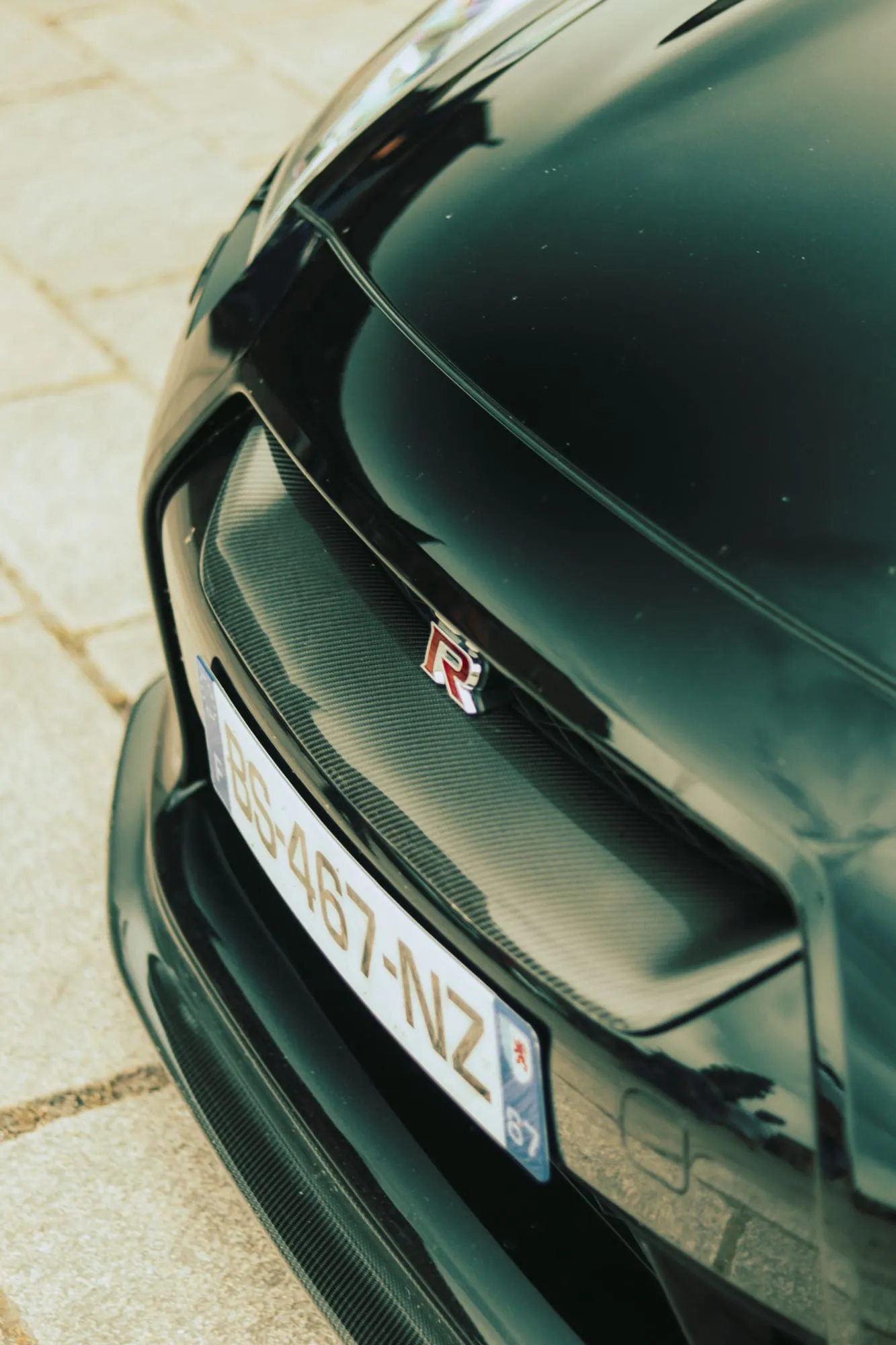 Close-up of a black car bonnet and badge