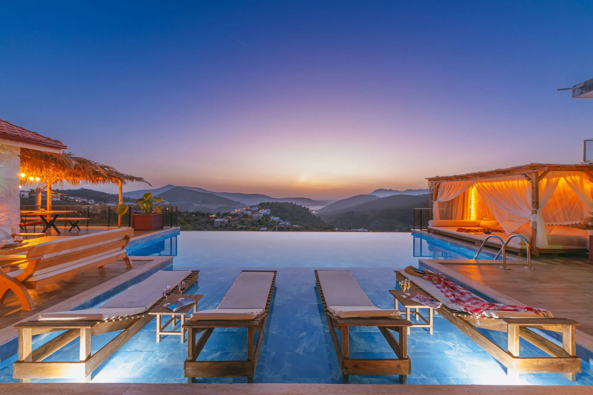 Infinity pool terrace overlooking the sea at sunset