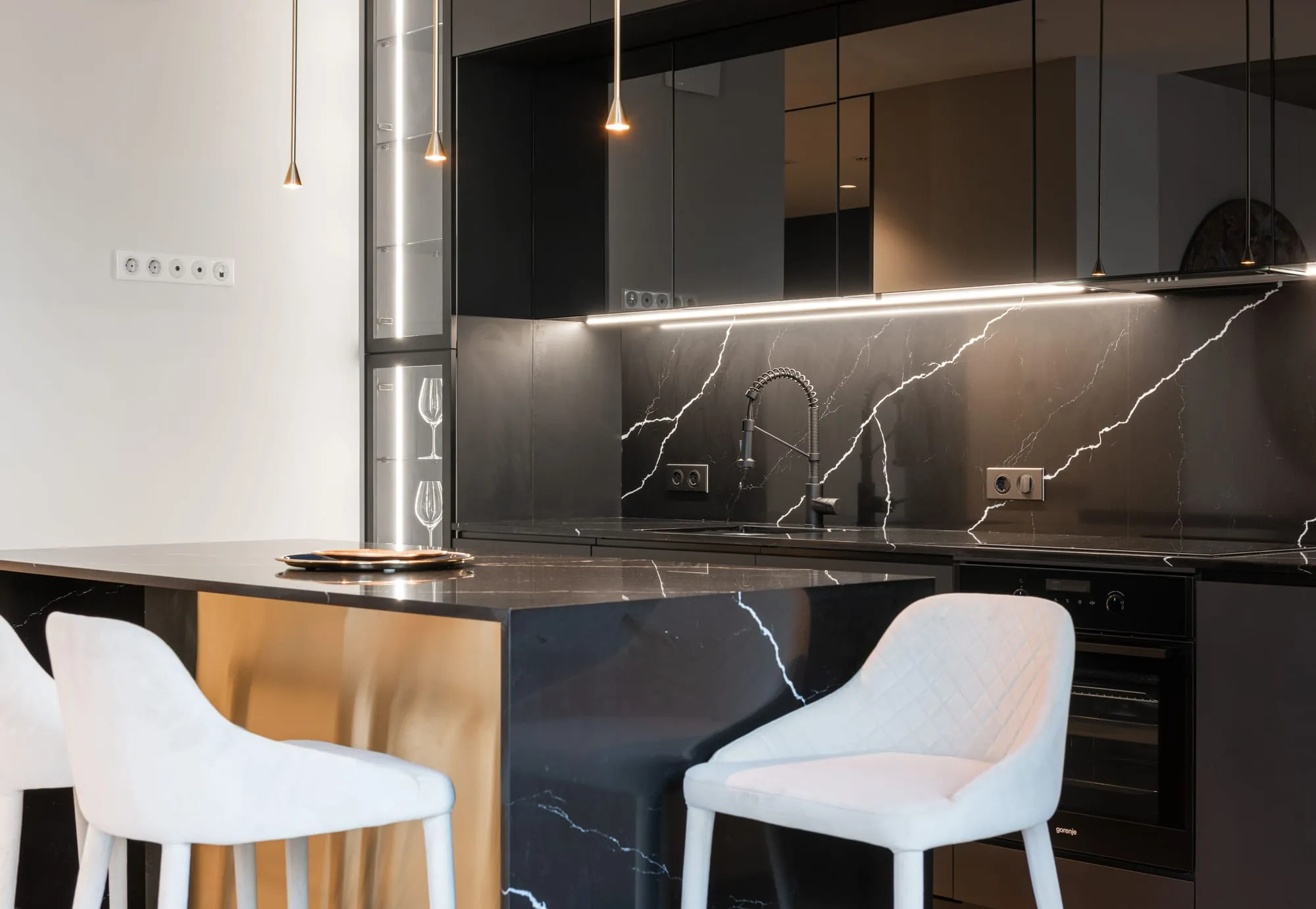 Black marble kitchen with an island and pendant lights