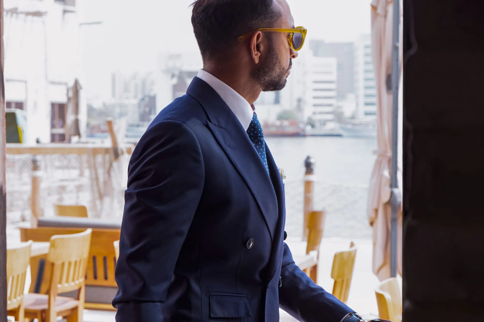 Portrait of a partner in a navy suit by the window