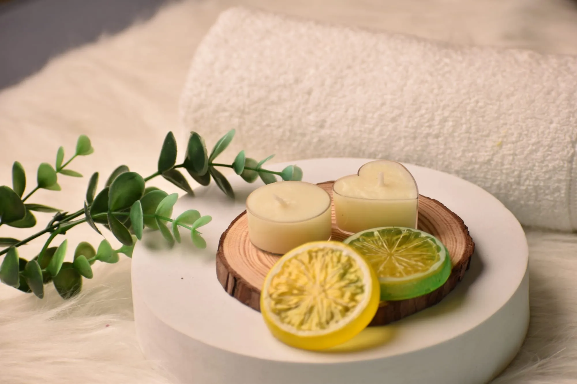 Rolled towels and fresh citrus on a spa table